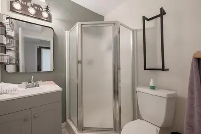 a bathroom with a shower and a toilet and a sink at Pet Friendly, 4 Bedrooms Plus Game Room, Easy Walk to Lake Granby & Beacon Landing Marina in Grand Lake