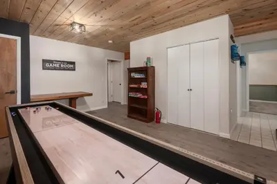 a bowling alley with a ping pong table in a room at Pet Friendly, 4 Bedrooms Plus Game Room, Easy Walk to Lake Granby & Beacon Landing Marina in Grand Lake