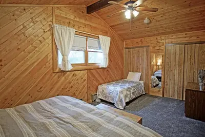 a bedroom with two beds in a log cabin at Large Wraparound Deck, Foosball Table, Close to Beacon Landing Marina in Grand Lake