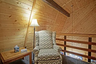 a room with a chair and a lamp in a cabin at Large Wraparound Deck, Foosball Table, Close to Beacon Landing Marina in Grand Lake