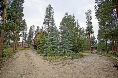 a dirt road in a forest with trees at Large Wraparound Deck, Foosball Table, Close to Beacon Landing Marina in Grand Lake