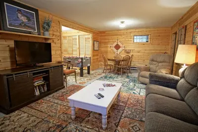 a living room with a couch and a tv at Large Wraparound Deck, Foosball Table, Close to Beacon Landing Marina in Grand Lake