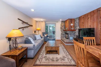 a living room with a couch and a tv at Beaver Village 1712 - Nicely Updated, 2 Queens Plus 2 Twins, Pool, Hot Tubs, Sauna in Winter Park