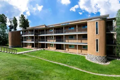 an apartment building with a large yard at Beaver Village 1712 - Nicely Updated, 2 Queens Plus 2 Twins, Pool, Hot Tubs, Sauna in Winter Park
