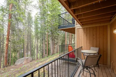 a balcony of a cabin with a table and chairs at Beaver Village 1712 - Nicely Updated, 2 Queens Plus 2 Twins, Pool, Hot Tubs, Sauna in Winter Park