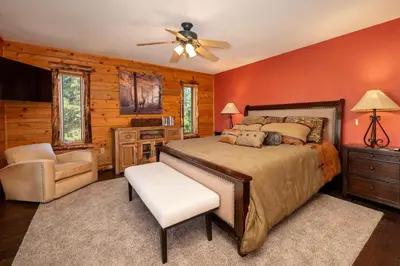 a bedroom with a bed and a ceiling fan at Outdoor Dining and Firepit, Pet Friendly, Breathtaking Views, High End Cabin in Grand Lake