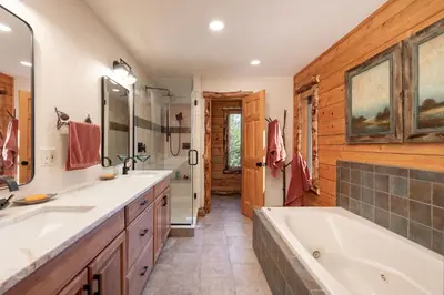 a bathroom with two sinks and a bath tub at Outdoor Dining and Firepit, Pet Friendly, Breathtaking Views, High End Cabin in Grand Lake