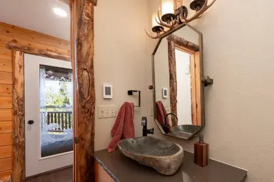 a bathroom with a sink and a mirror at Outdoor Dining and Firepit, Pet Friendly, Breathtaking Views, High End Cabin in Grand Lake