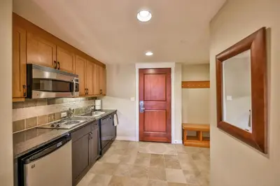a kitchen with a sink and a microwave at Pool, Hot Tub, Ski In Ski Out, Bike Storage for Summer Guests in Winter Park