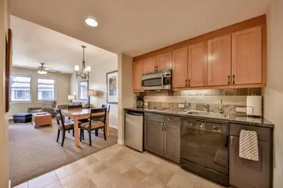 a kitchen with a table and a dining room at Pool, Hot Tub, Ski In Ski Out, Bike Storage for Summer Guests in Winter Park
