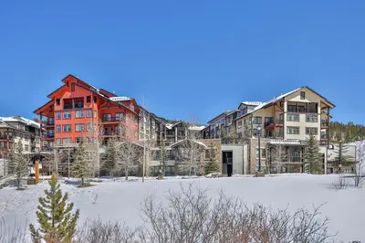 a large building in the middle of a snow covered field at Pool, Hot Tub, Ski In Ski Out, Bike Storage for Summer Guests in Winter Park