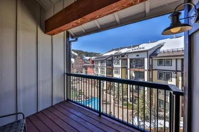 a balcony with a view of a city at Pool, Hot Tub, Ski In Ski Out, Bike Storage for Summer Guests in Winter Park