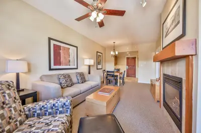 a living room with a couch and a fireplace at Pool, Hot Tub, Ski In Ski Out, Bike Storage for Summer Guests in Winter Park