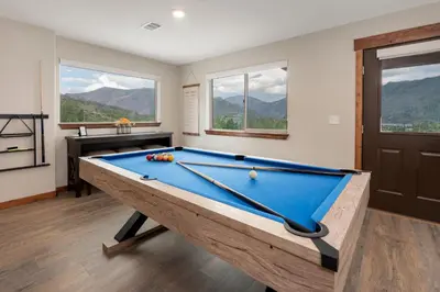 a pool table in a room with windows at Pool Table, Expansive Mountain Views, New Construction, Close to Town in Grand Lake