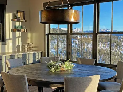 a dining room table with chairs and a large window at Luxury Home, Game Room, Outdoor Fireplace, Amazing Views in Grand Lake
