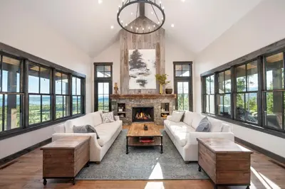 a living room with a couch and a fireplace at Luxury Home, Game Room, Outdoor Fireplace, Amazing Views in Grand Lake