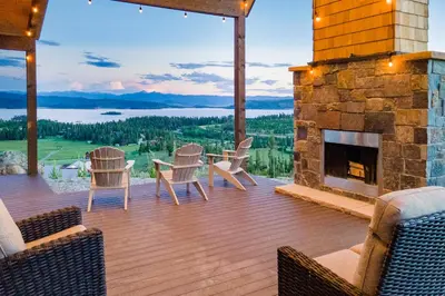 a patio with a fireplace and a table and chairs at Luxury Home, Game Room, Outdoor Fireplace, Amazing Views in Grand Lake