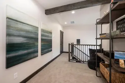 a hallway with a large painting on the wall at Luxury Home, Game Room, Outdoor Fireplace, Amazing Views in Grand Lake