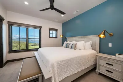 a bedroom with a large bed and a window at Luxury Home, Game Room, Outdoor Fireplace, Amazing Views in Grand Lake