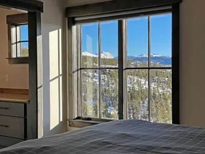 a bedroom with a large window with a mountain view at Luxury Home, Game Room, Outdoor Fireplace, Amazing Views in Grand Lake