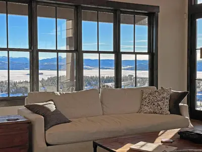 a living room with a couch and large windows at Luxury Home, Game Room, Outdoor Fireplace, Amazing Views in Grand Lake