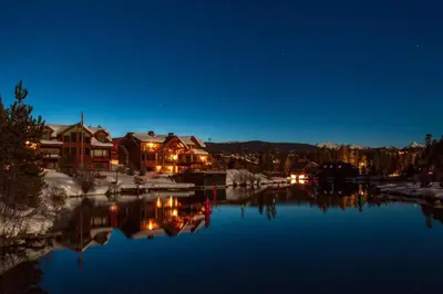 a view of a lake at night with houses at Great Deck with Gas Grill, Outdoor Firepit, 2 Blocks From Main Street in Grand Lake