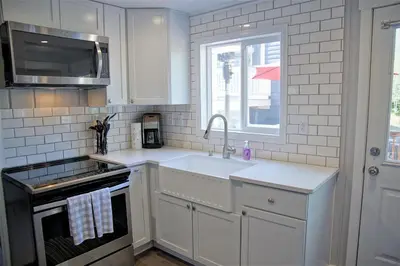 a white kitchen with a sink and a window at Great Deck with Gas Grill, Outdoor Firepit, 2 Blocks From Main Street in Grand Lake