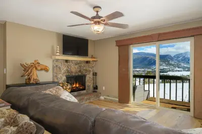 a living room with a couch and a fireplace at Lula in Grand Lake