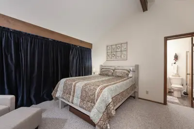 a bedroom with a bed and a toilet in it at Outdoor Pool, Fireplace, Athletic Club, Covered Balcony with Views in Fraser