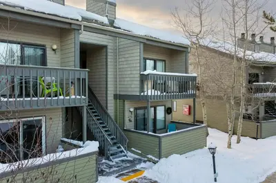 a house with a deck in the snow at Outdoor Pool, Fireplace, Athletic Club, Covered Balcony with Views in Fraser