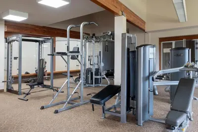 a gym with treadmills and exercise equipment at Outdoor Pool, Fireplace, Athletic Club, Covered Balcony with Views in Fraser