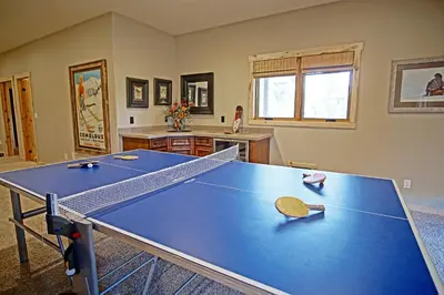 a ping pong table in a room with a ping pong racket at Incredible Views, Hiking from the Property, 4 Ensuite Baths, Luxury Home in Grand Lake