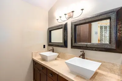 a bathroom with two sinks and a mirror at Incredible Views, Hiking from the Property, 4 Ensuite Baths, Luxury Home in Grand Lake