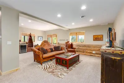 a living room with a couch and a table at Incredible Views, Hiking from the Property, 4 Ensuite Baths, Luxury Home in Grand Lake