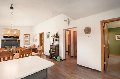 a living room with a kitchen and a dining room at Pet Friendly - Cozy & Modern Cabin - Surrounded by Nature in Grand Lake