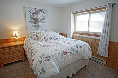 a bedroom with a bed and a window at Pet Friendly, Firepit, Wrap around Porch, Close to Lake Granby and Highland Marina in Grand Lake