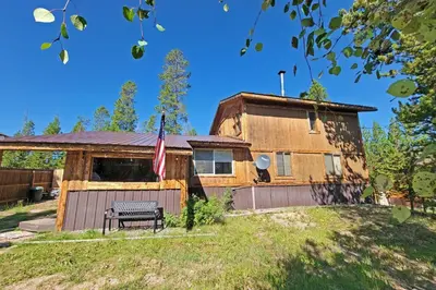 a house with a bench in front of it at New Listing, Great Backyard with Firepit, Pet Friendly, Wood Burning Stove in Grand Lake