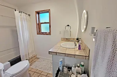 a white bathroom with a sink and a toilet at New Listing, Great Backyard with Firepit, Pet Friendly, Wood Burning Stove in Grand Lake