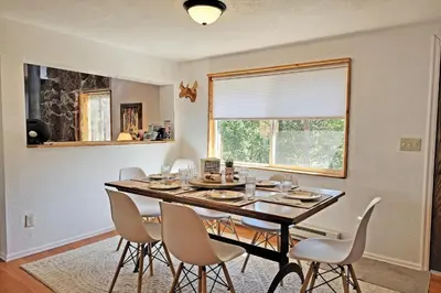 a dining room with a table with chairs and a window at New Listing, Great Backyard with Firepit, Pet Friendly, Wood Burning Stove in Grand Lake