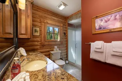 a bathroom with a sink and a toilet at Spacious Cabin - Quality Finishes & Furniture, 2 Large Bedroom Suites Plus Den Bedroom Suite in Grand Lake