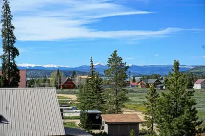 a town with trees and mountains in the background at New Hot Tub, Firepit, Laundry, Big Front Deck with Great Views in Grand Lake