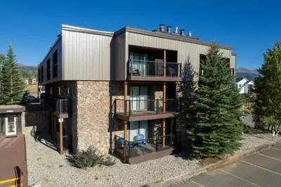 an apartment building with two balconies on it at Versatile Rental, Firepit, Balcony with Grill and Outdoor Seating in Fraser