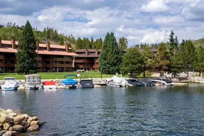 a group of boats parked in a marina on a lake at Lakefront Condo, Ground Floor, Ideal for Couples or Families in Grand Lake