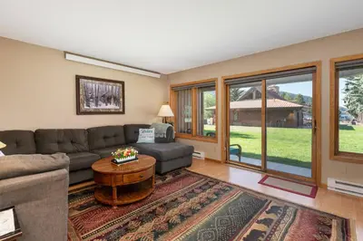 a living room with a couch and a table at Lakefront Condo, Ground Floor, Ideal for Couples or Families in Grand Lake