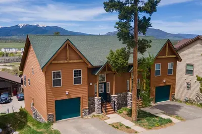 an image of a house with mountains in the background at Private Garage, Washer and Dryer, Amazing Views of Byers Peak, Pet Friendly in Fraser