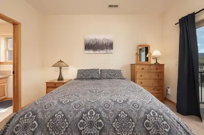 a bedroom with a bed and a window at Private Garage, Washer and Dryer, Amazing Views of Byers Peak, Pet Friendly in Fraser