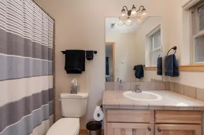 a bathroom with a toilet and a sink and a mirror at Private Garage, Washer and Dryer, Amazing Views of Byers Peak, Pet Friendly in Fraser