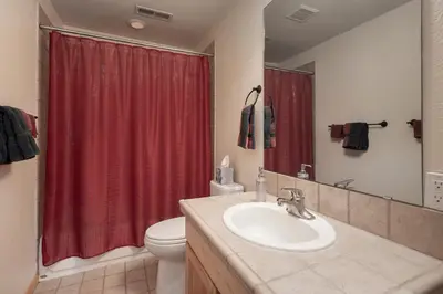 a bathroom with a sink and a red shower curtain at Private Garage, Washer and Dryer, Amazing Views of Byers Peak, Pet Friendly in Fraser