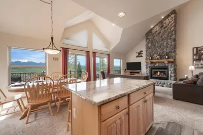 a kitchen and living room with a fireplace at Private Garage, Washer and Dryer, Amazing Views of Byers Peak, Pet Friendly in Fraser
