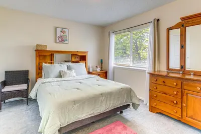 a bedroom with a bed and a dresser and a window at Pet-Friendly Retreat with Fenced Yard in Denver in Denver